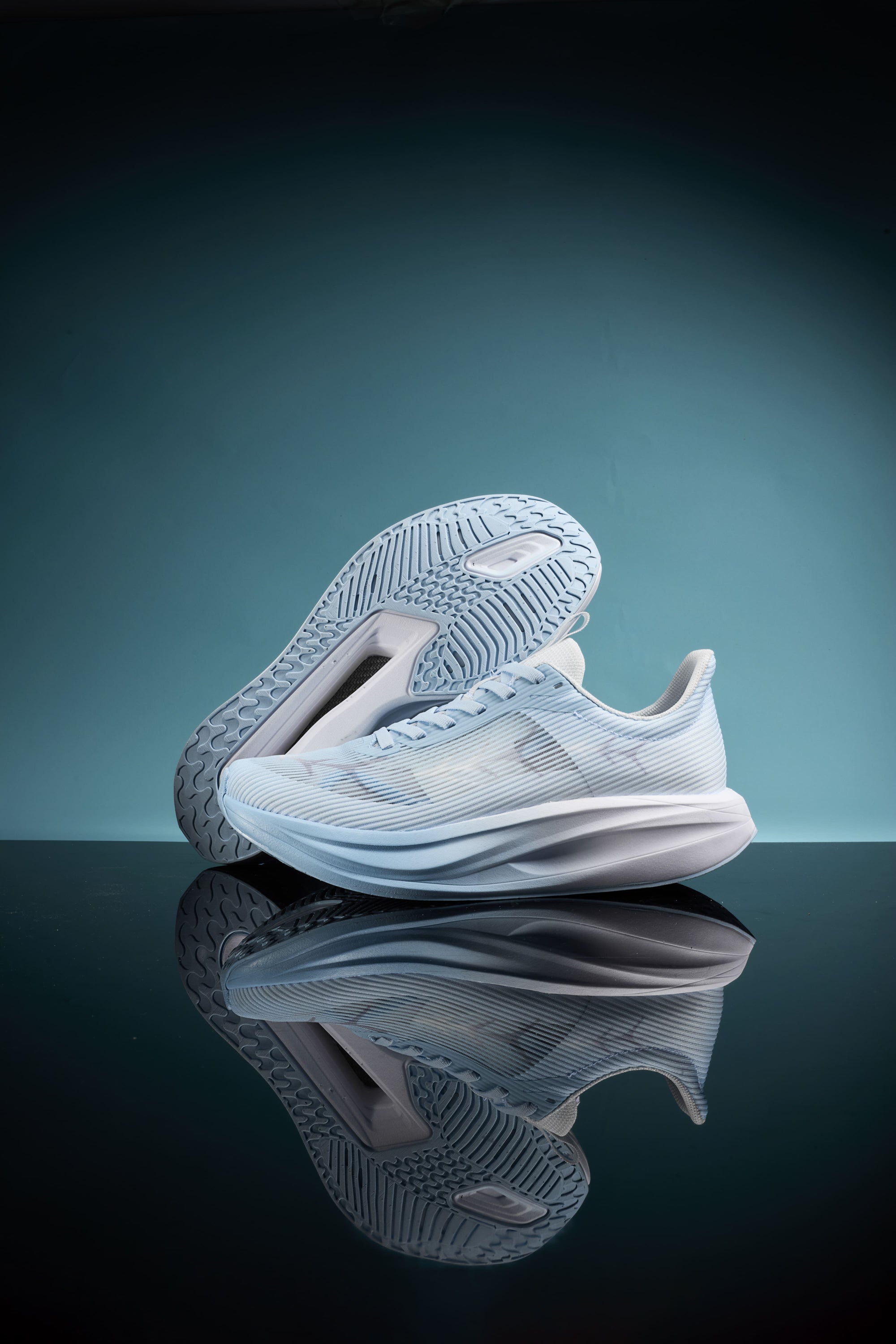 Light blue GoldenArmor sports shoes with integrated heddle upper, golden half - palm carbon fiber, 3D bionic arch design, TEPOR - WAVE energy - gathering midsole, and rubber outsole, shown in a product display setting.