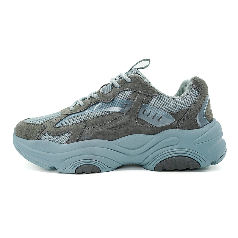 A pair of grey - blue chunky sneakers with a unique design, featuring a combination of materials and a thick sole, suitable for casual wear.