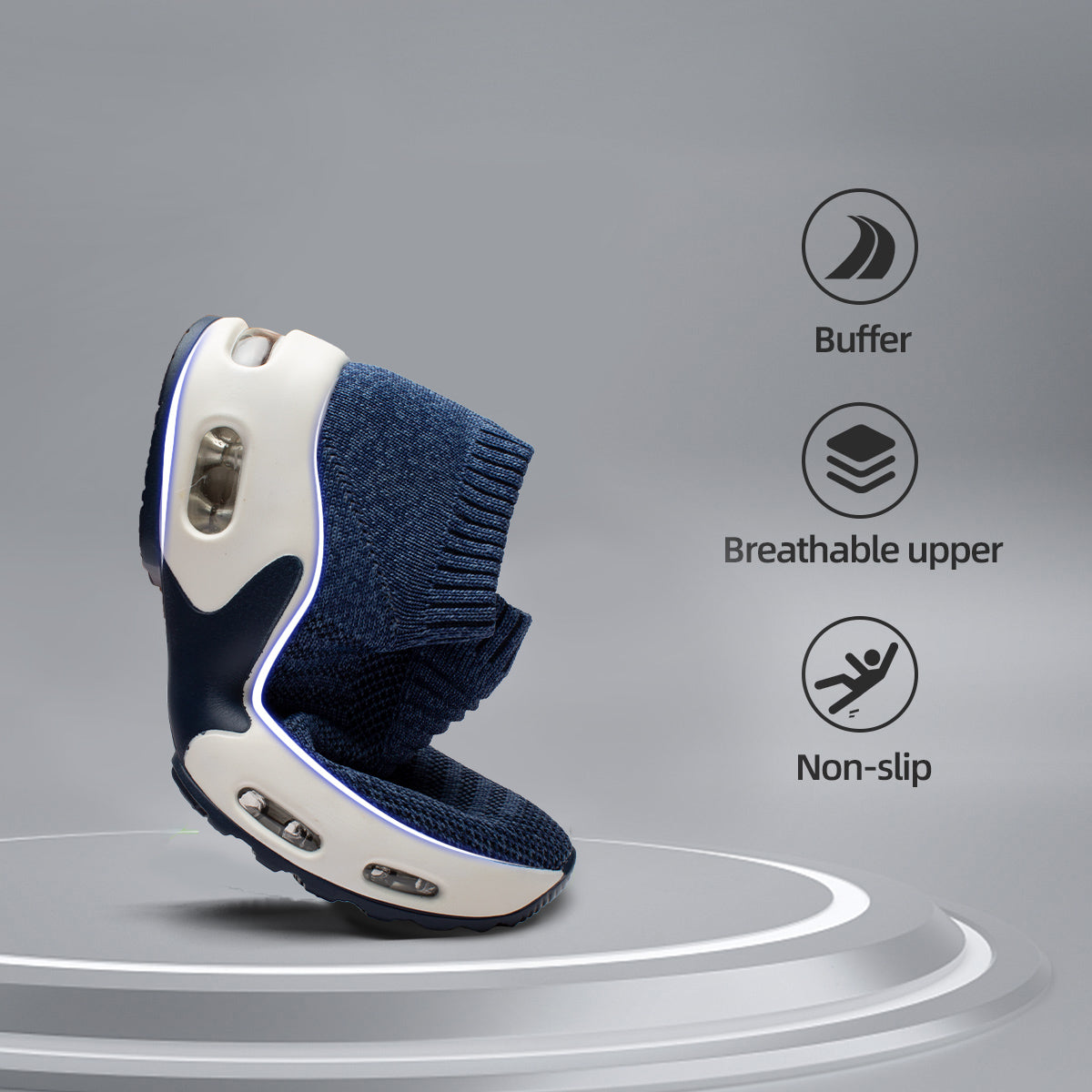A navy blue sneaker being flexed on a podium to demonstrate flexibility, accompanied by icons for buffer, breathable upper, and non-slip features.