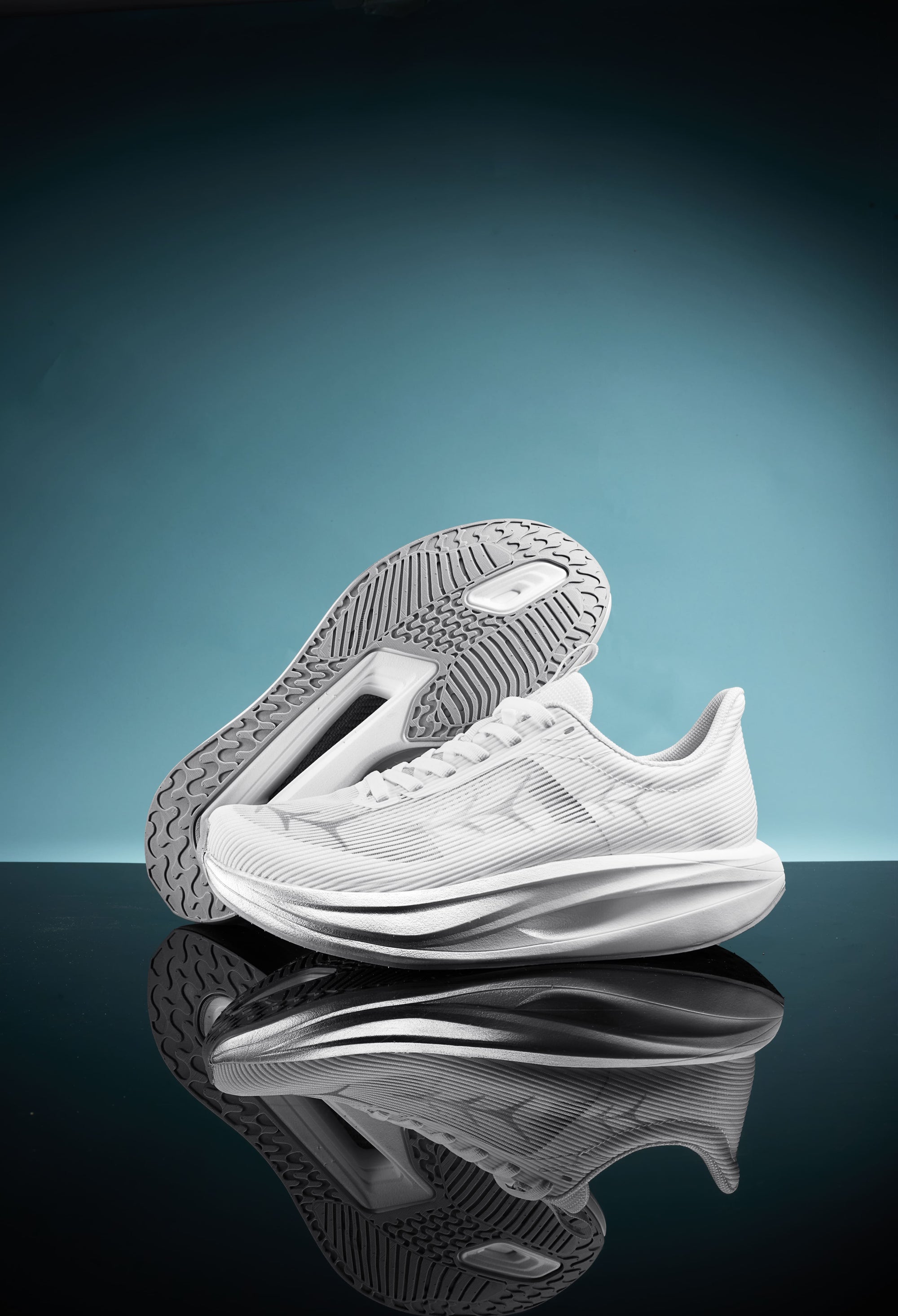 White sports shoes with a sleek design, featuring a breathable upper and a textured sole, displayed against a teal background with a reflective surface.
